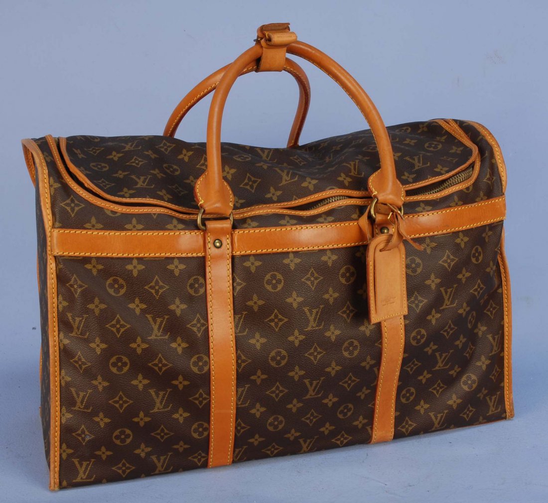 LOUIS VUITTON ZIP TOP WEEKENDER.: Twin handled duffle style bag in logo monogram vinyl with saddle tan leather trim, cotton lining having eight interior pockets with elastic top. Marked on trim "Louis Vuitton Paris Made in France" num