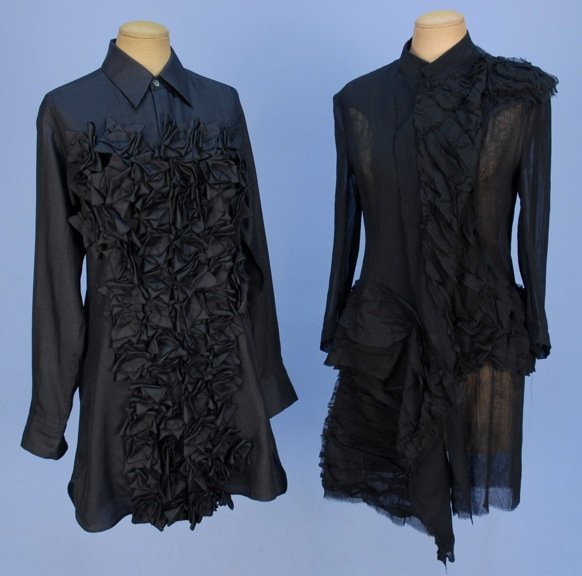 TWO YOHJI YAMAMOTO LONG BLOUSES.: One black silk with collar and long cuffed sleeve having vertical bands of folded self fabric decorating the front, menswear hem. B-36, L-34. One sheer polyester with 3/4 sleeve having asymmetrical cr