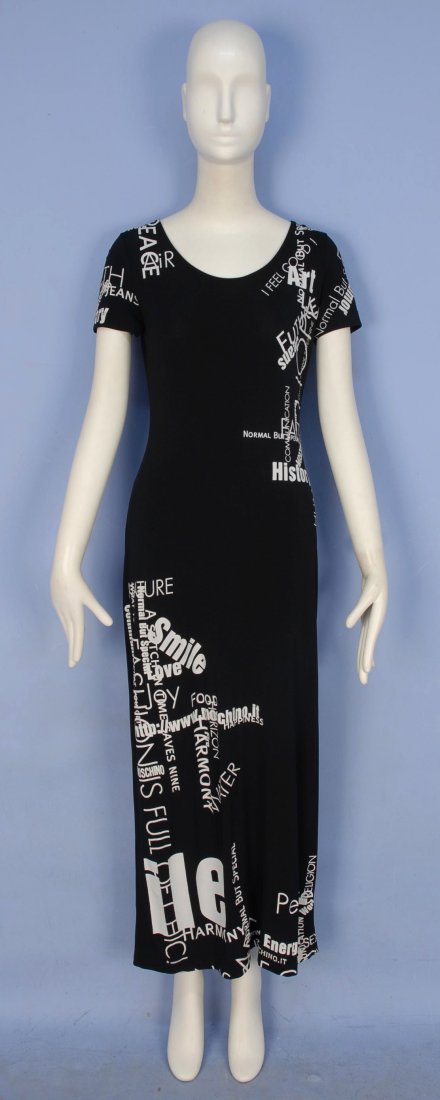 MOSCHINO PRINTED KNIT MAXI DRESS.: Short sleeve black synthetic knit decorated with printed words in white, side slit. Labeled. Marked size 10. Excellent.