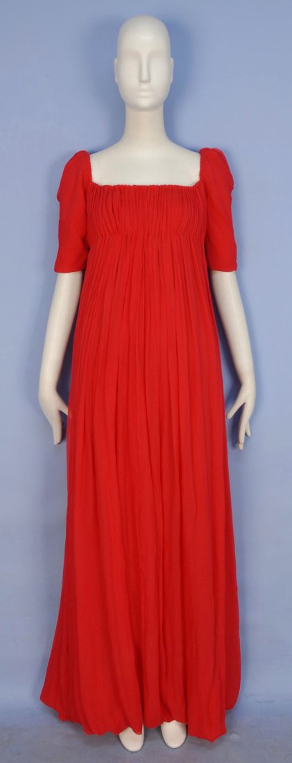ALEXANDER McQUEEN DEADSTOCK CHIFFON EMPIRE GOWN.: Red crinkled silk with short puffed sleeve, gently fitted high waist, bubble hem, silk lining, inside zippered corset lined in cream satin. Labeled. Marked size 40. (Small section of waistline unstitc