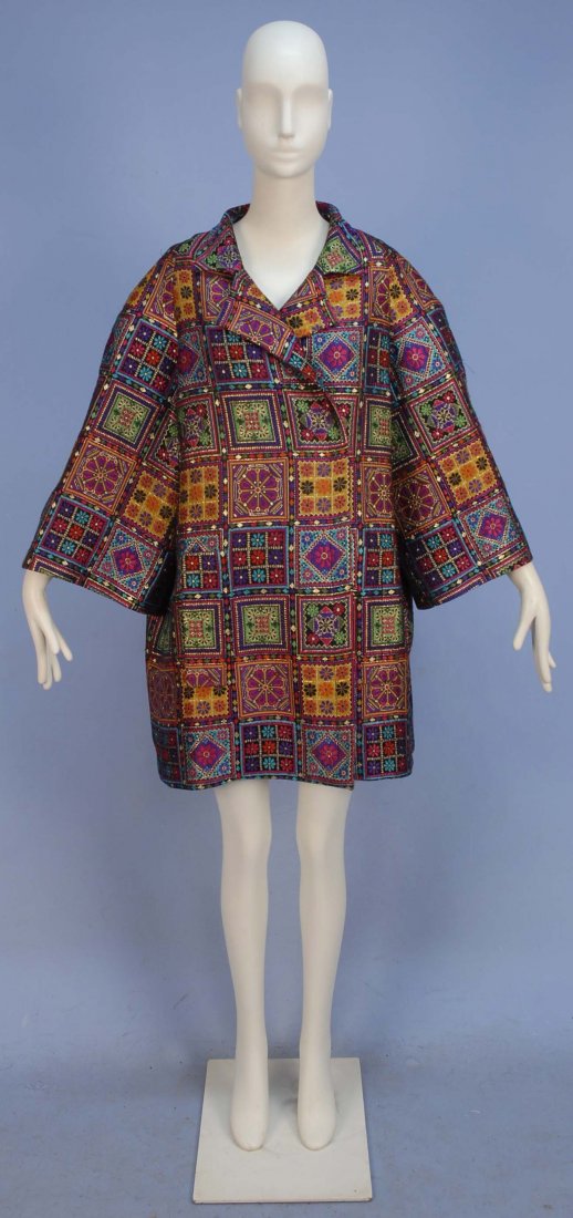 CHRISTIAN LACROIX PARIS BROCADE EVENING COAT.: Black ground with vibrant multicolored embroidery in floral blocks with metallic gold details, oversized styling with side seam pockets and quilted lining. B-50, L-37. (Some pulled threads) very good.