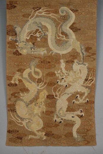 JAPANESE TAPESTRY, EARLY 20th C.: Three coiled dragons on couched background of cloud band design. 78 x 48. (Loose couching) good.