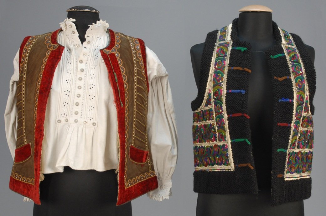 TWO ROMANIAN EMBROIDERED VESTS, EARLY 20th C.: Both shearling: One trimmed in back wool with magenta, green and purple embroidery, B-38, L-21. One brown punchwork decorated leather with scarlet red wool fleece trim, B-37, L-21. Together with a lin