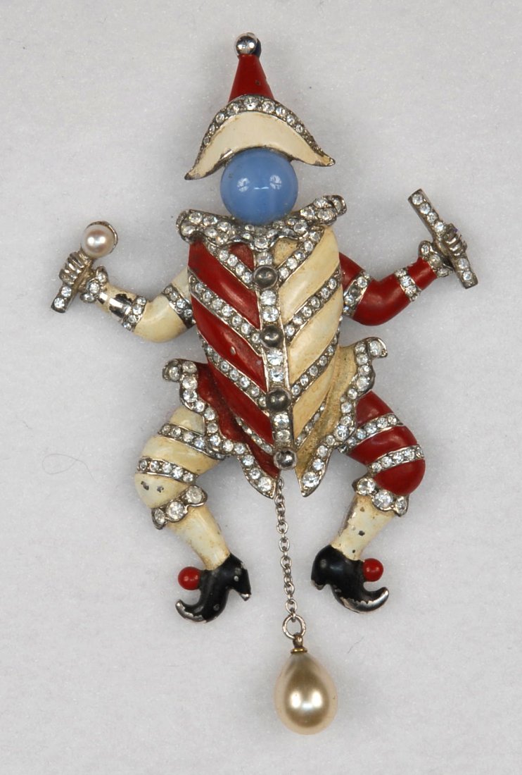 MARCEL BOUCHER "PUNCHINELLO" FUR CLIP/ PIN 1940.: Articulated figure of a clown in rhodium plated and enameled base metal, decorated in red and white enamel and set with moonstone color cabochon head, rhinestones and faux pearls. Unsigned, inside cov