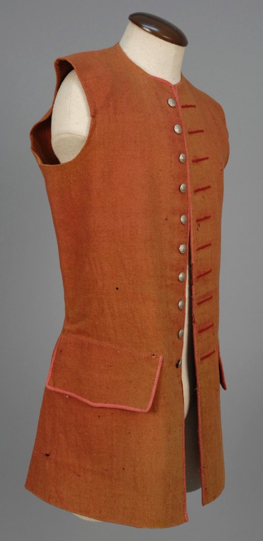 GENTS AMERICAN WOOL BLEND WAISTCOAT, 18th C.: Red informal waistcoat pieced with half shoulder cap and underarm gusset, having red tape binding to neck, front opening and wide, slightly shaped faux pocket flaps, stamped metal buttons, unlined, fl