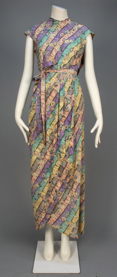 PRINTED CHIFFON GOWN with SEQUINS, 1930s.: Pastel printed silk having diagonal floral bands, cap sleeve with single back drape, back self buttons and wrap skirt with self belt decorated with iridescent sequins. B-41, W-28, H-42, L-56. (Some se