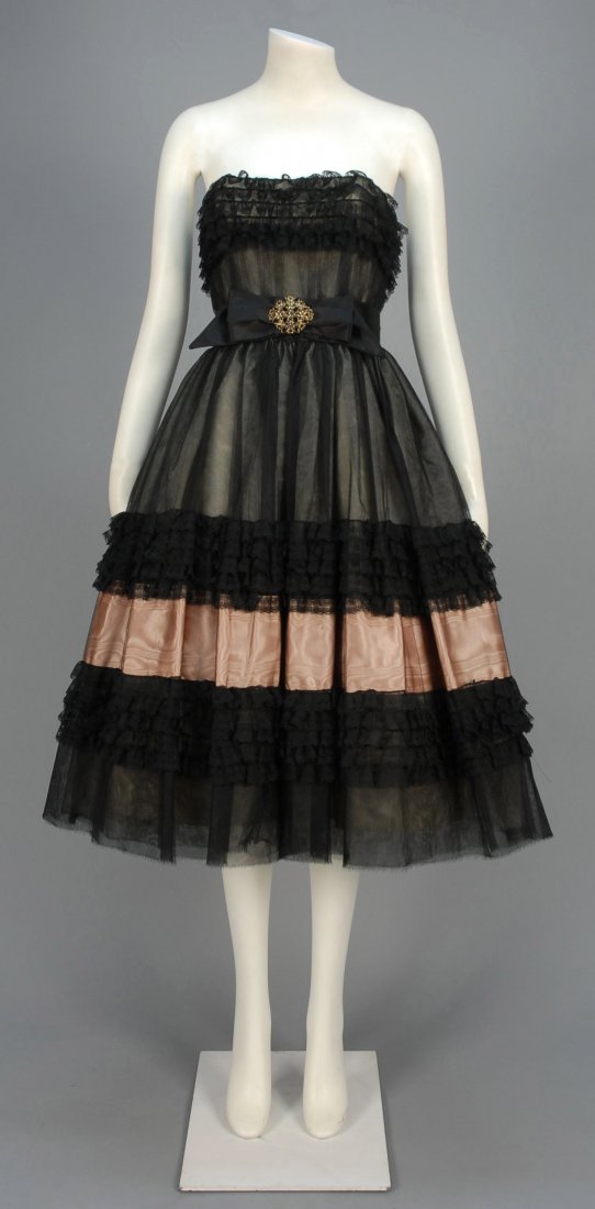 MAGGY ROUFF PARIS COUTURE COCKTAIL DRESS, 1950s.: Boned bodice in black tulle over white silk edged along top with five ruffles of Chantilly lace, worn strapless or with narrow tulle strap, full tulle over-silk skirt having wide band of pink moire si