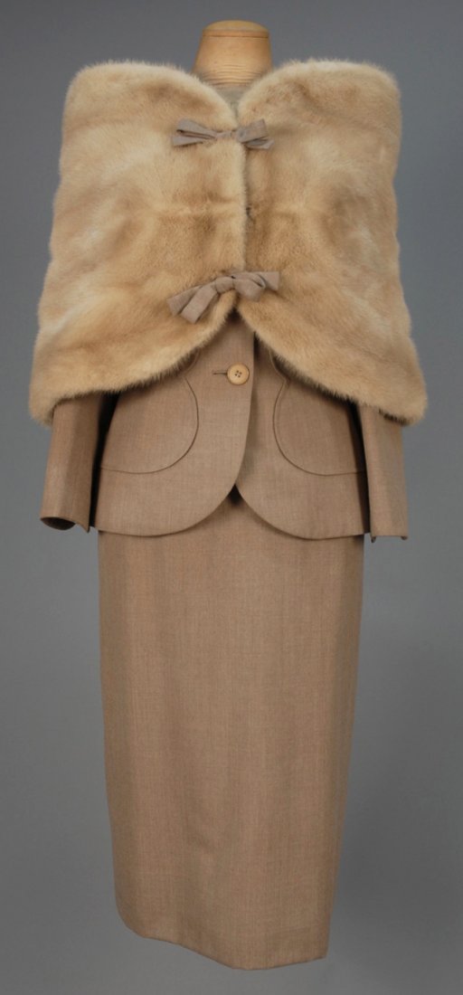 IRENE THREE PIECE SUIT, EARLY 1950s.: Oatmeal wool collarless jacket having scalloped overlay, two buttons over hidden button placket, matching A-line skirt and wool lined mink capelet with wool bow details. Labeled. B-37, W-26, H-39, ski