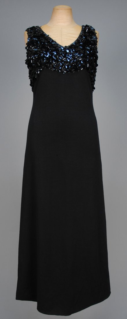 GINO PAOLI WOOL EVENING DRESS with SEQUINNED BODICE,: Sleeveless black knit having empire bodice covered in large sequins, satin lining. Labeled. B-36, W-28, H-36, L-52. (Slight soiling under arms small pull front center) very good.