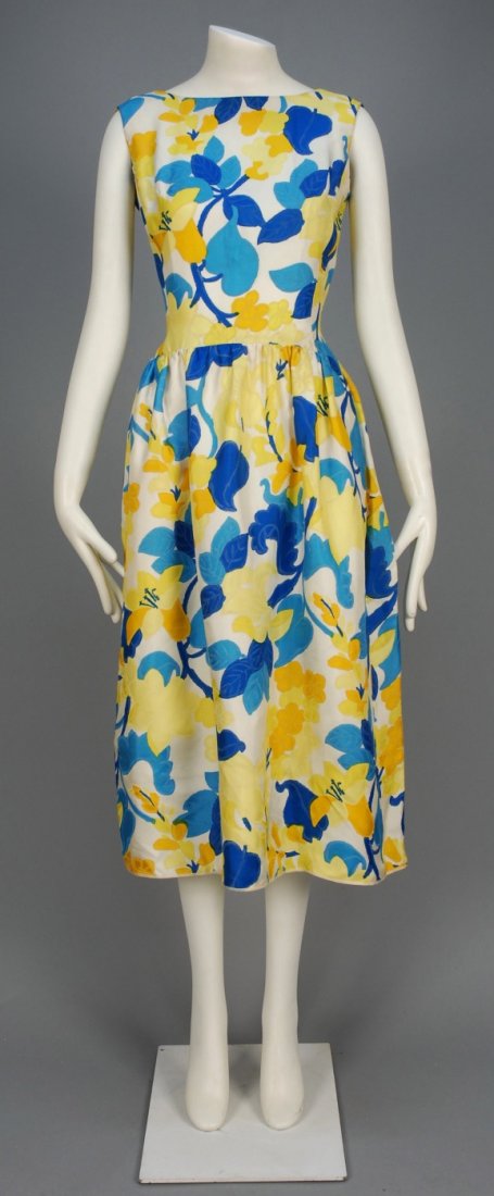 CHRISTIAN DIOR PARIS PRINTED SILK SUMMER DRESS, 1960s.: Sleeveless cream twill with large scale floral in shades of blue and yellow, boatneck dropping to a graceful curve mid-back, full skirt gathered into set-in waist, side seam pockets, silk organza lini