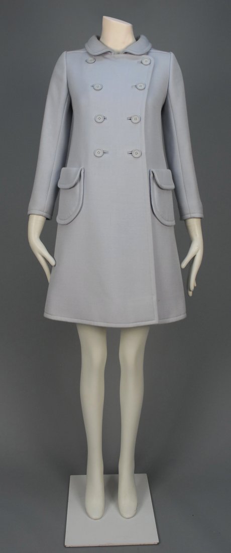 COURREGES PARIS WOOL COAT, 1960s.: Pale grey-blue double breasted with round collar and U-shaped pockets with flap, back belt and pointed yoke. Labeled. B-36, W-36, H-42, L-36. Excellent.
