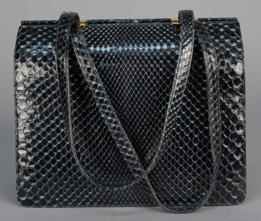 JUDITH LEIBER PYTHON HANDBAG.: Black twin handled bellows style with hinged center compartment having one zippered and three open pockets, satin lining, brass hardware. Labeled. 8 3/4 x 3 1/2 x 7 with 8 inch handle. Excellent.
