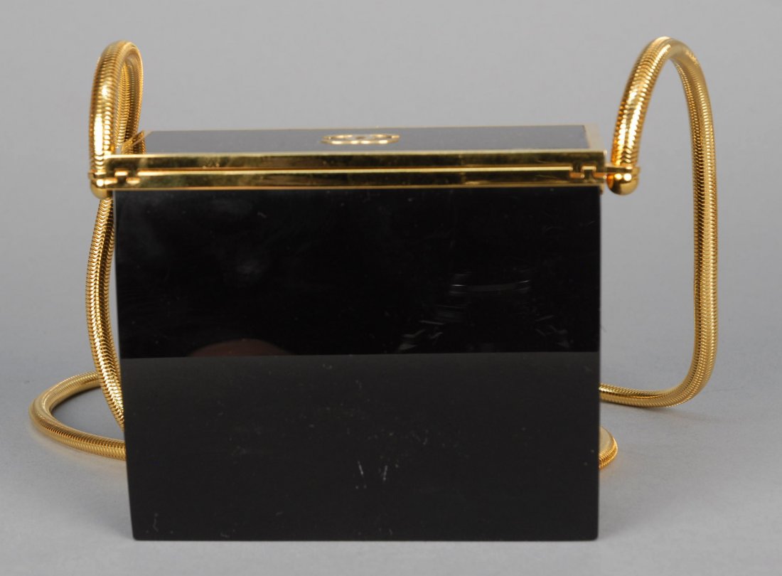 CHANEL GOLD and BLACK LUCITE EVENING BAG.: Rectangular box with lift lid having Chanel logo and cable shoulder strap. 5 x 4 1/4 x 2 with 22 inch strap. Excellent.