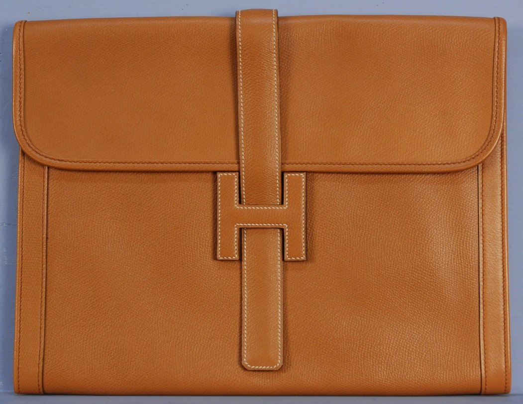 HERMES PARIS LARGE JIGE ELAN H CLUTCH.: Tan envelope style having belted "H" logo closure with contrast topstitching and canvas lining. Labeled. 10 1/2 x 13 1/4. Excellent.