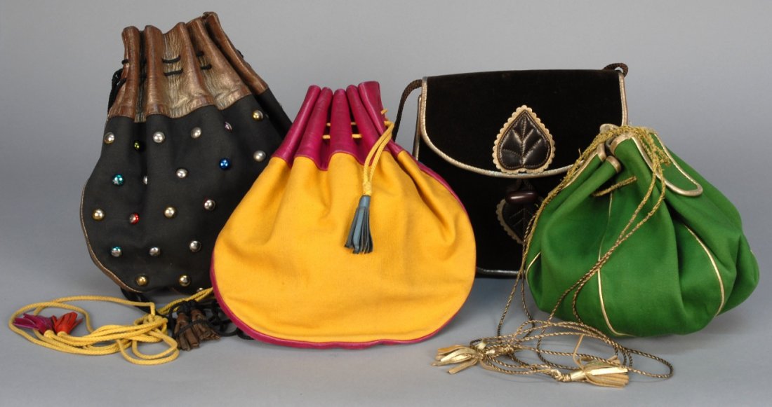 THREE YVES SAINT LAURENT DRAWSTRING PURSES, 1970s.: All cotton canvas with leather trim: One yellow, turquoise and magenta. One black with colored studs and brown trim. One green with gold leather trim. Smallest 8 x 8, largest 10 1/2 x 10 1/2. (Yellow