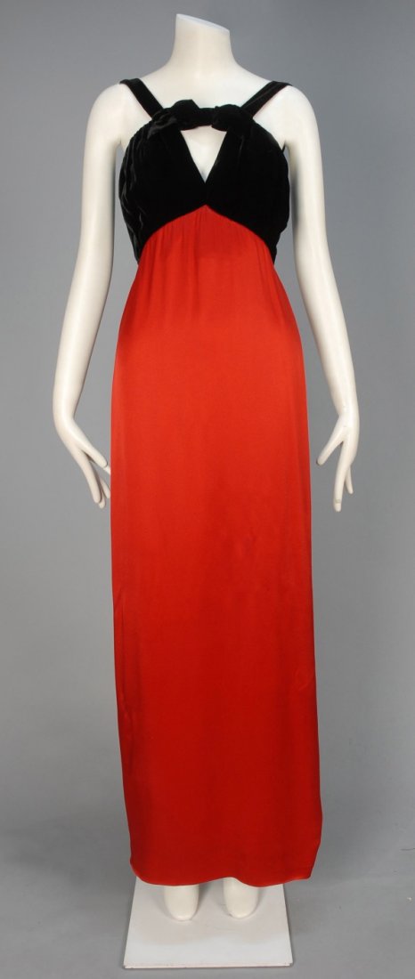 SAINT LAURENT RIVE GAUCHE SATIN and VELVET EVENING: Red rayon blend with sleeveless slightly gathered black velvet empire bodice with keyhole and bow detail, deep side slit and silk lining. Labeled. B-34, high W-26, H-38, L-59. Excellent.