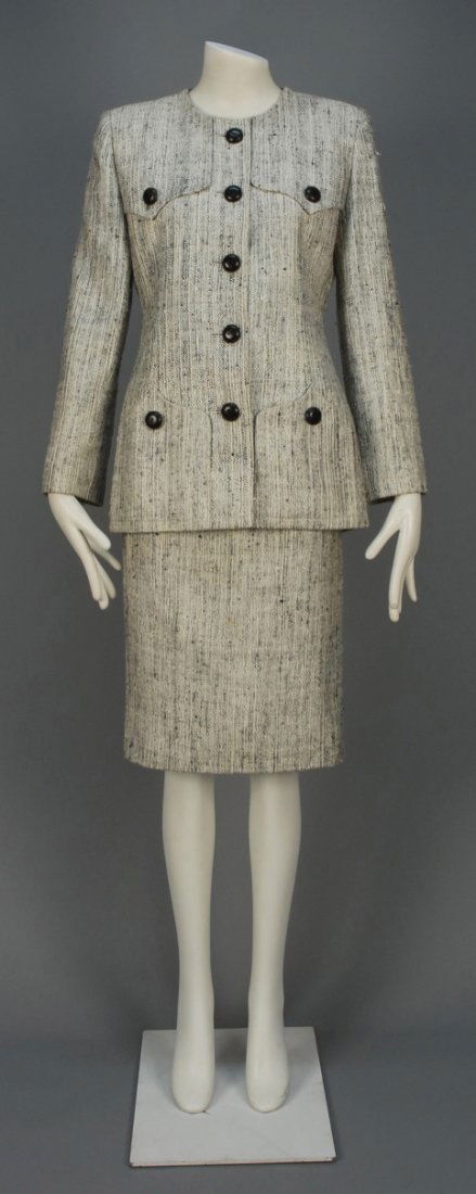 GIVENCHY PARIS TWEED SKIRT SUIT, 1980s.: Black and white, probably wool and silk blend, long collarless jacket having four double ogee pockets (two faux), composition buttons and pencil skirt. "Couture" label. B-38, jacket L-29, W-29, H-38,