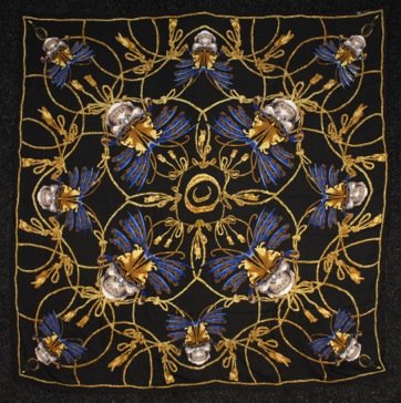 TWO ALEXANDER McQUEEN SILK CHIFFON SCARVES.: One x-ray skull print on leopard ground (unlabeled). One printed with skulls having butterfly headdresses amid ropes and tassels. 53 x 53. Excellent.