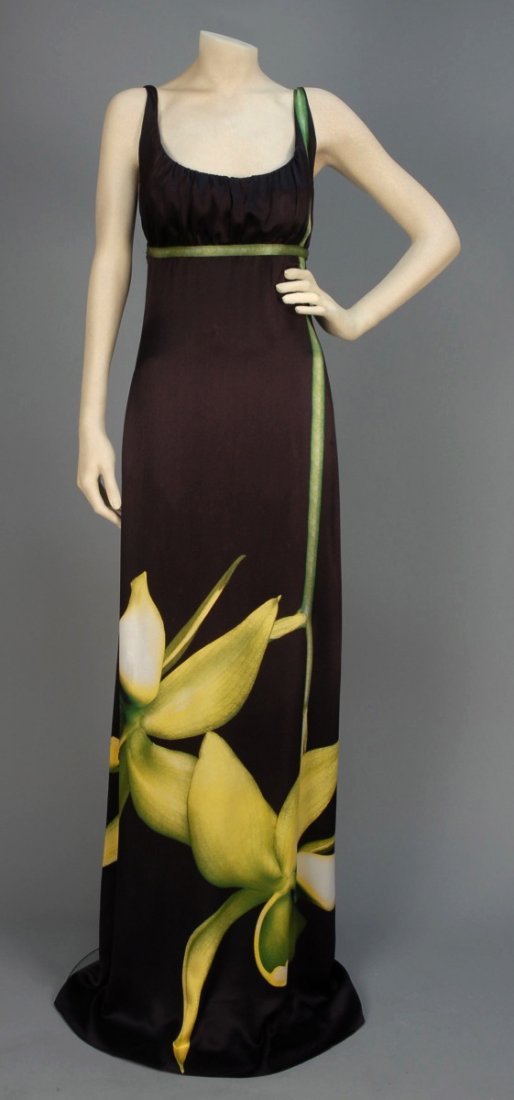 ALEXANDER McQUEEN PRINTED SILK MAXI DRESS.: Sleeveless aubergine charmeuse having slightly gathered empire bodice with narrow strap, scoop neck and low back, printed with oversized orchid flowers, chiffon under-skirt. Labeled. B-34, high W-30, 