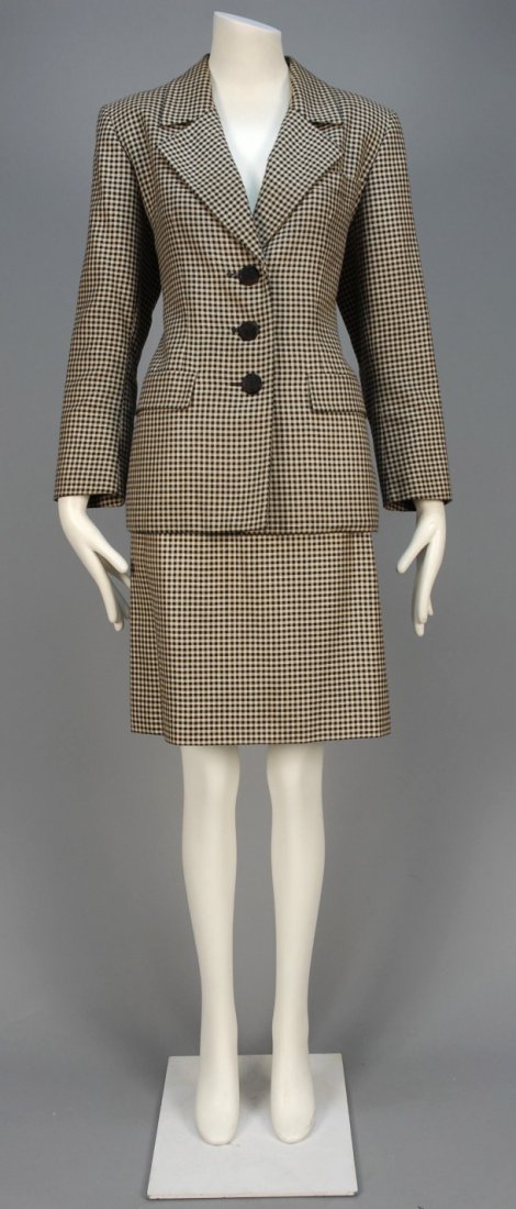 YVES SAINT LAURENT RIVE GAUCHE WOOL and SILK SKIRT: Black and tan plaid long jacket having hip pockets with flap, single breast pocket, uncuffed sleeve with single button, matching A-line skirt with front pleats and angled pockets. Labeled. B-40, Sh-16