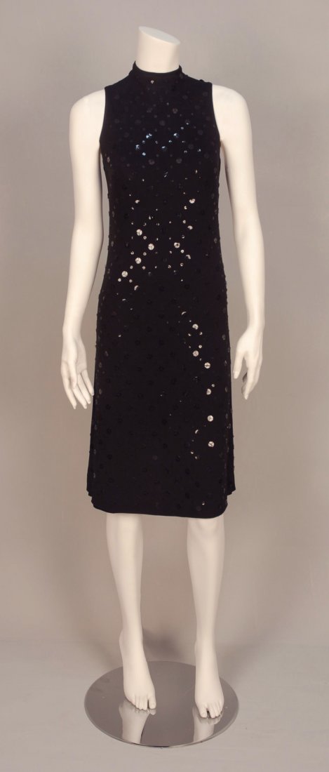 ALEXANDER McQUEEN SEQUINED COCKTAIL DRESS.: Sleeveless black rayon knit narrow A-line decorated in a diamond pattern of large and small sequins, knit lining. Labeled. B-32, W-30, H-34, L-41. Excellent.