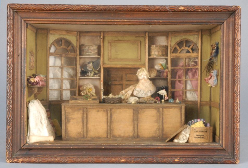 MILLINERS SHOP MINIATURE ROOM SETTING, c. 1970.: Wood diorama of shop interior having milliner, hats, materials, etc. in deep shadowbox, by Betty Ann Twigg DBA Elspeth. 16 x 10 x 8 excluding frame. Excellent. BUYER RESPONSIBLE FOR ANY SHIPPING ARRAN