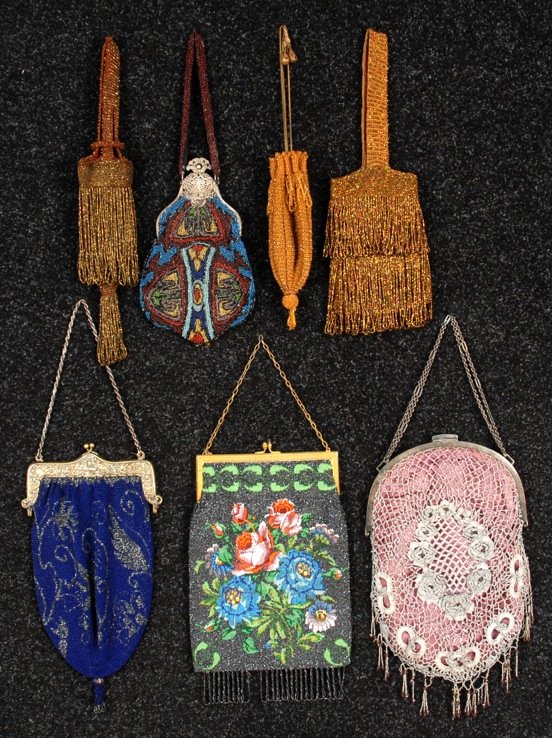 SIX BEADED BAGS, LATE 19th - EARLY 20th C.: One cathedral frame with polychrome abstract design. Two floral with hinged frame: One polychrome, one cobalt and charcoal. Three with iridill beads and looped fringe. Together with a metallic lace ba