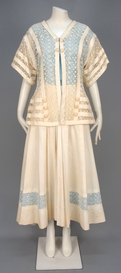 LINEN and LACE ENSEMBLE, c. 1912.: Cream lace jacket having short kimono sleeve decorated with linen bands and knotted cord buttons, worn over sleeveless blue linen shell, matching long skirt with pleats and lace hem band backed in blu
