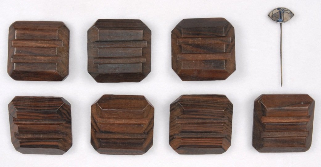 JOSEF HOFFMANN WEINER WERKSTATTE BUTTONS, EARLY 20th C.: Seven square rosewood buttons with beveled edges and two horizontal recessed lines. Most stamped with Weiner Werkstatte, Tudor rose and "JH" conjoined monogram. 1 3/4 square. Excellent. Together with