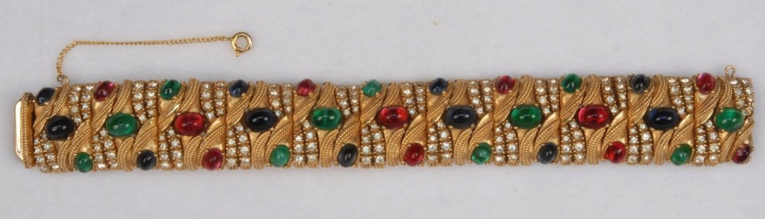 CINER BRACELET with FAUX JEWELS, MID 20th C.: Wide hinged gold tone band with diagonal pattern of rhinestones and colored cabochons. Signed. 1 x 7 inches. Excellent.