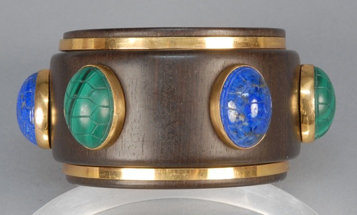 ISABEL CANOVAS EBONY BANGLE, 1980s.: Massive ebony cuff set with six large scarabs in malachite and lapis. Signed. Diameter- 4 1/2 including scarabs, 2 1/2 wrist diameter. Excellent.