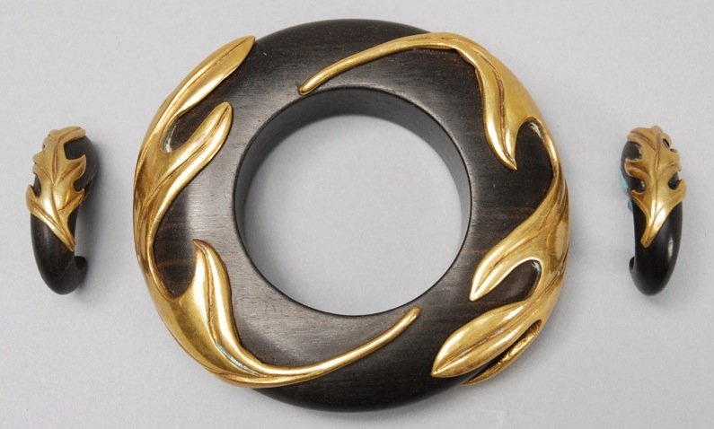 ISABEL CANOVAS EBONY BANGLE and EARRING SET, 1980s.: Large ebony bangle mounted with bronze leaf form decoration, matching crescent form clip earrings. Signed. Diameter- 4 1/2. Excellent.