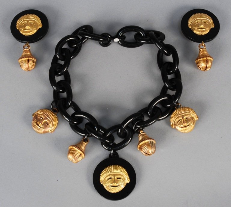 ISABEL CANOVAS ATTRIBUTED NECKLACE and EARRING SET,: Black resin chain necklace with gilt bronze mask heads and bells, matching clip earrings. Necklace 12 inches, earrings, 2 x 3 1/2. Excellent.