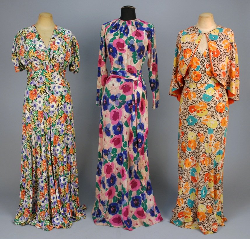 THREE FLORAL PRINTED CREPE DRESSES, 1930s.: One sleeveless with surplice bodice and matching capelet, B-34, W-26, L-57, (stain on lower skirt). One short sleeve with ruched empire bodice above set-in waist, B-38, W-28, L-59. One long raglan sle