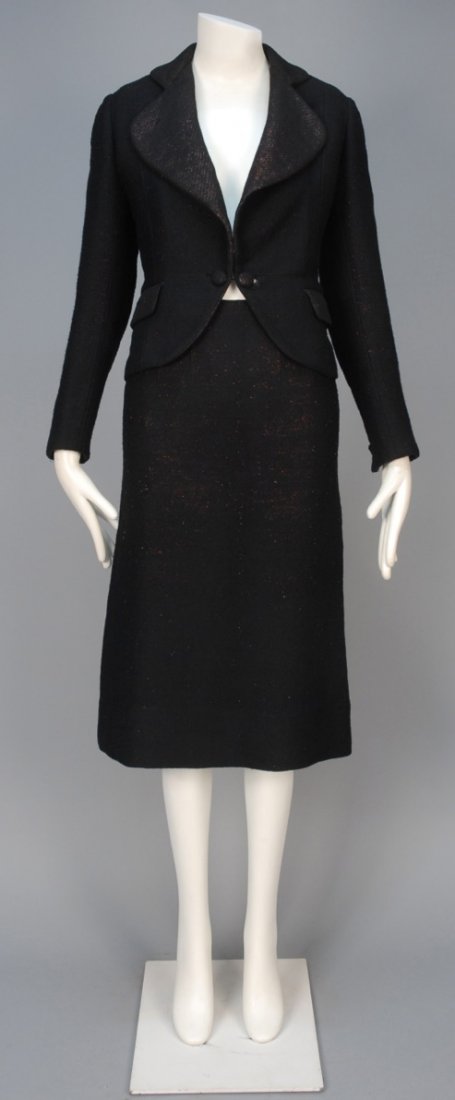 WOOL and METALLIC SKIRT SUIT, 1936.: Twisted black wool yarn with red metallic threads having rounded collar, lapel and front hem, flap pockets and self button closure and cuff, matching over the knee pencil skirt. I. Magnin & Co. label.