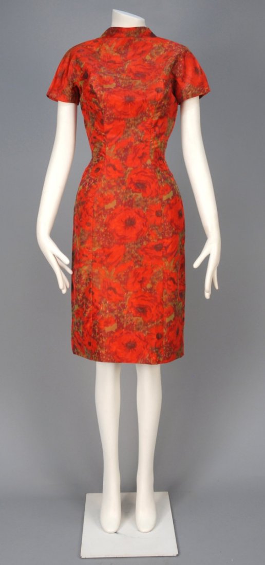 SUZY PERETTE WARP PRINTED COCKTAIL DRESS, 1950s.: Cap sleeve princess line satin printed with poppies in shades of red and green, having high neck, deep V-back with pleating. Labeled. B-34, W-26, H-38, L-40. Excellent.