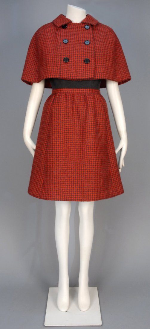 NORMAN NORELL WOOL DAY DRESS and CAPE ENSEMBLE, 1960s.: Short sleeve grey bodice with curved yoke and red and grey houndstooth skirt with hidden front pockets, slightly gathered at waist, matching houndstooth double breasted capelet with black buttons. Nor