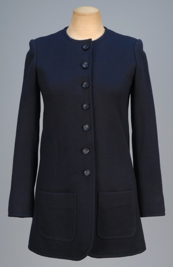YVES SATIN LAURENT COUTURE JACKET, 1969.: Navy blue collarless style with patch pockets, topstitched details and composition buttons, silk lining. Labeled and stamped 22534. B-34, Sh-14 1/2, Slv-22 1/2, L-30. (Minor surface moth damage to one