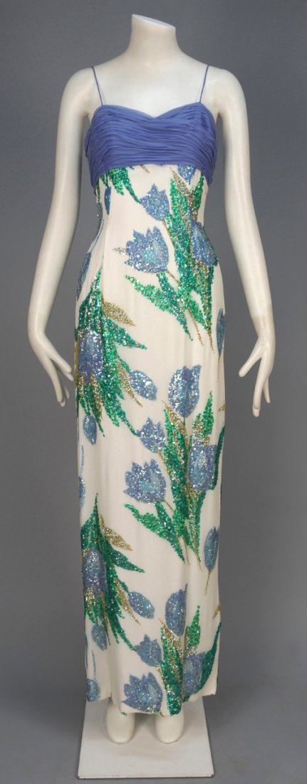 SEQUINED SILK EVENING GOWN, c. 1960.: Sleeveless white crepe having a printed tulip pattern decorated with blue and green sequins, empire bodice in periwinkle ruched chiffon with spaghetti strap and matching chiffon trapezoid shawl. Hong 