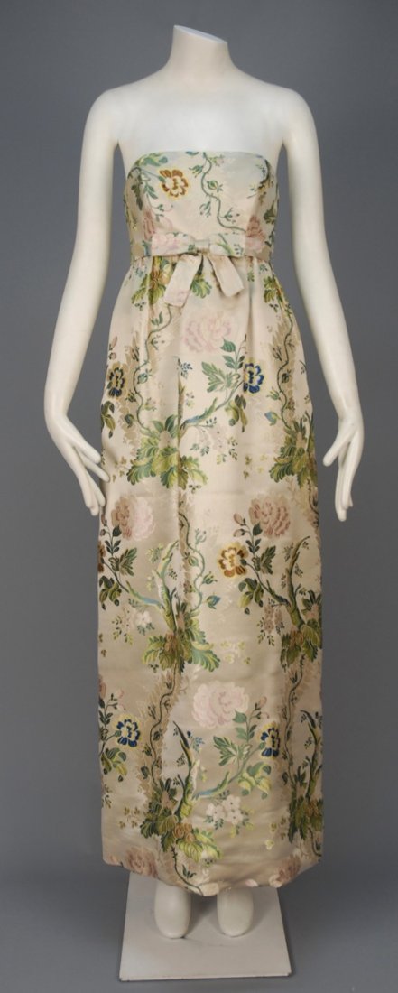 RICHARD TAM SILK BROCADE EVENING DRESS and JACKET, c.: Champagne silk brocaded in an 18th C inspired polychrome floral, strapless gown having boned Empire bodice with attached self belt and center bow, cropped princess line jacket with back self buttons a