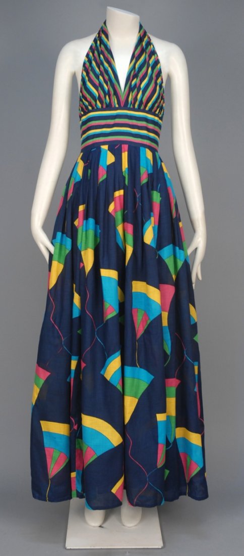 JEAN PATOU PARIS PRINTED COTTON HALTER DRESS, 1970s.: Polychrome print on navy ground having striped halter with wide waistband and full pleated skirt with abstract print, satin underskirt. Labeled. B-36, W-26, L-58. (Needs cleaning) otherwise excellent.