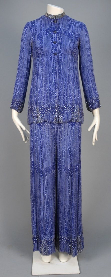 PAULINE TRIGERE PRINTED CHIFFON PANTS ENSEMBLE, 1970s.: Blue and white abstract printed silk, blouse having stand collar with rhinestones, gathered below the bust, self buttons and rhinestone studded hem and cuff, matching wide leg trousers with elastic wa