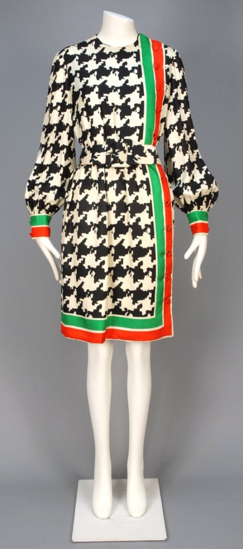 DONALD BROOKS HOUNDSTOOTH DAY DRESS and SCARF, 1970s.: Black and white printed rayon twill long sleeve dress with red and green striped trim, off-center self button closure, wide belt and matching scarf. Labeled. B-38, W-27, L-39, scarf 31x31. Excellent.