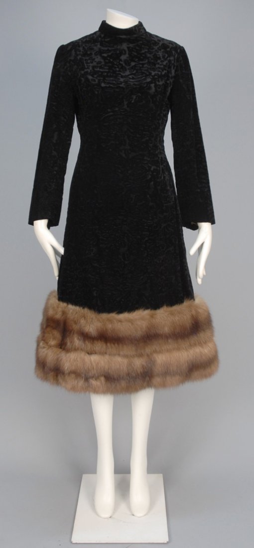BILL BLASS MINK TRIMMED COCKTAIL DRESS, c. 1970.: Long sleeve black karakul cut velvet having stand collar and A-line skirt trimmed with two bands of mink fur. Labeled. B-34, W-28, H-40, L-45. Excellent.