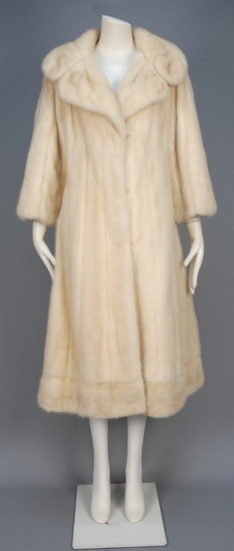 PIERRE CARDIN MINK COAT, 1970s.: White mid calf length fur with notched shawl collar, hook & eye closures and fancy champagne lining with pleated details and velvet bands. Pierre Cardin for Michael Forrest label. B-40, Sh-16 1/2, Slv