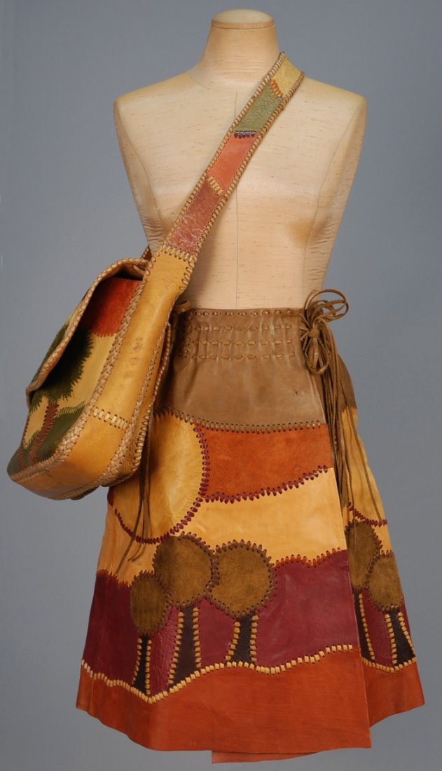 CHAR PIECED LEATHER and SUEDE SKIRT and SHOULDER BAG,: A-line wrap skirt having stylized tree design in earth tones with whipstitching and fringed tie. Messenger style shoulder bag in the same pattern with two front pockets (some soiling). Skirt W-24, L-2