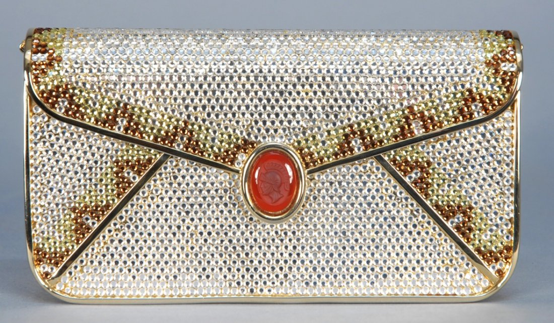 JUDITH LEIBER CRYSTAL MINAUDIERE.: Envelope style with oval intaglio clasp, covered in crystals with crystal border design in brown and gold, gold leather interior with optional chain strap. Labeled. 6 1/2 x 3 1/2. Excellent.