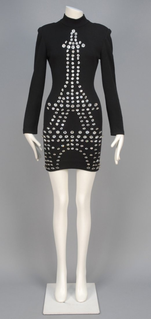 PATRICK KELLY PARIS CENTENNIAL EIFFEL TOWER DRESS,: Long sleeve black wool knit sheath with mock turtleneck and padded shoulder decorated with oversized Eiffel Tower comprised of rhinestone buttons in varied sizes. Labeled. Nearly identical version in