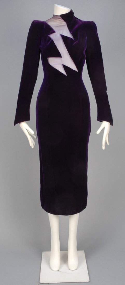 THIERRY MUGLER VELVET and CHIFFON DRESS, 1980s.: Royal purple velvet with long sleeve and high neck, having a lightning bolt chiffon insert on bodice, narrow tapered skirt with back slit and slightly curved hem. Labeled. B-32, W-25, H-36, L-50. (Tin