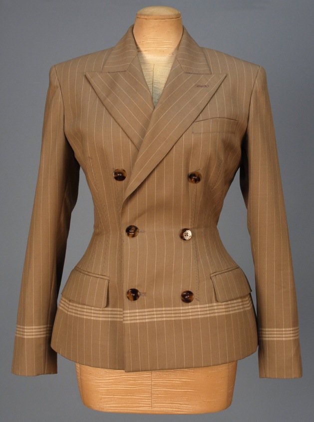 JEAN PAUL GAULTIER DOUBLE BREASTED WOOL BLAZER, 1987.: Tan with cream pinstripe having horizontal bands above cuff and hem, faux tortoise buttons, fitted through the waist with vertical darts having large zig-zag stitching, welt pockets with flap, heavily